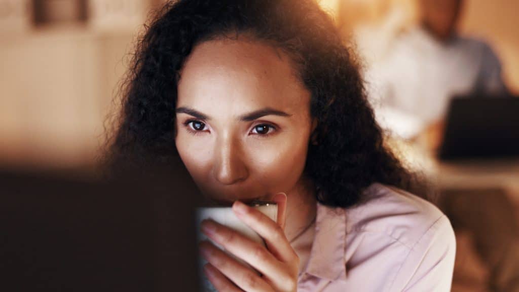 A woman looking at a screen